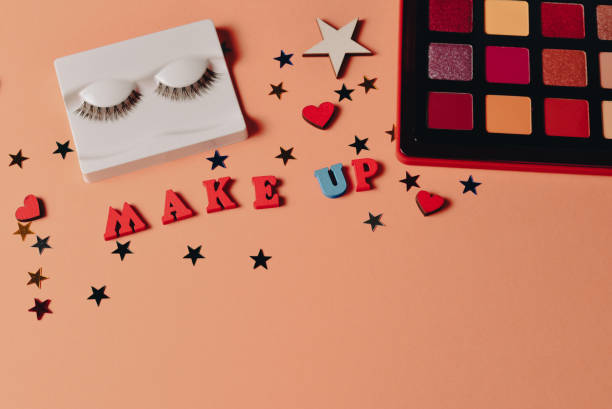 istock Eye shadow palette on orange background. Copy space. 1409734630