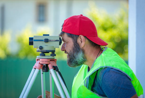 istock A man works with an optical level to level the landscape. 1409736378