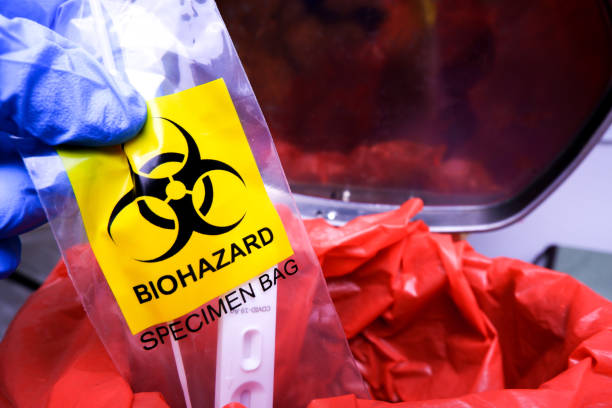 istock Infectious garbage is being thrown into the red infectious waste bin 1409737872