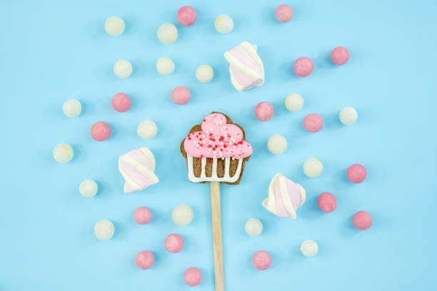 istock banner cookies on a stick and candy on a blue background. Delicious sweets top view and copy space. dragees and lollipops 1409740149