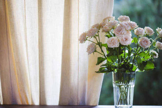 istock roses in glass vase 1409748783