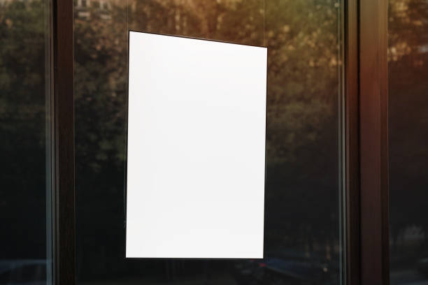 istock Empty advertising placard with mock up place hanging vertically at store window 1409749141