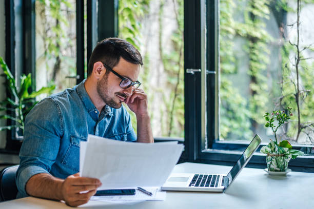 istock Male entrepreneur or businessman expert reading documents. 1409751288