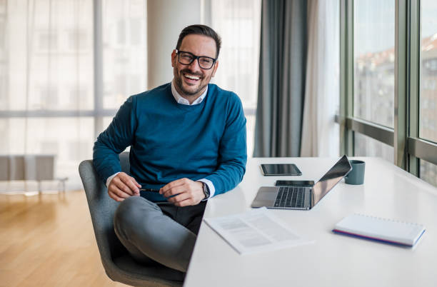 istock Portrait of confident smiling entrepreneur with laptop computer. 1409751346