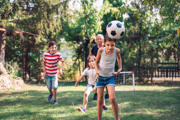 istock Family playing soccer in the back yard. 1409754226