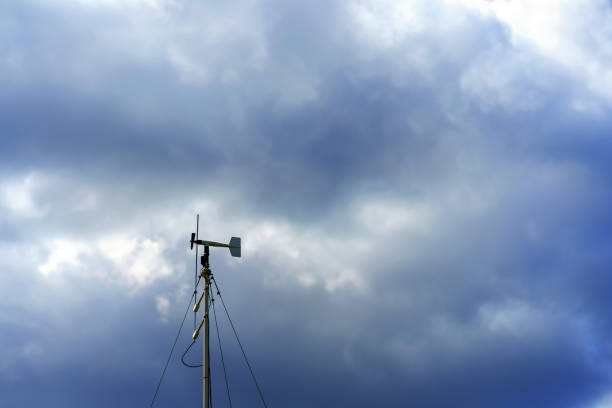 Wind speed meter with propeller against the background of a stormy sky