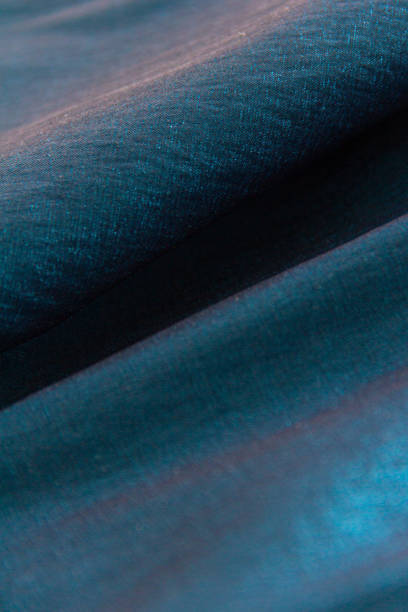istock Black blue green wavy satin fabric 1409754775