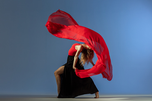 dancer with red textile in motion
