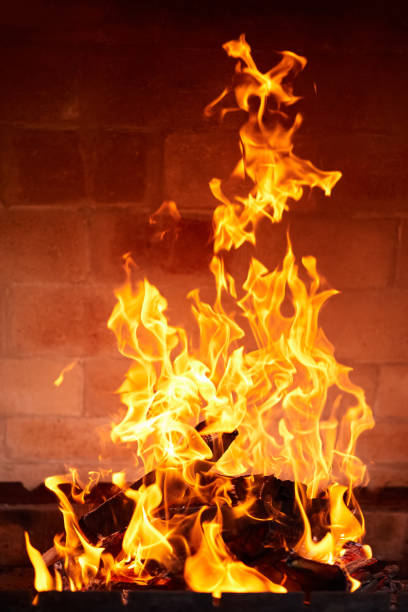 istock Orange flame from burning firewood in a brick grill. Close-up, selective focus 1409754867