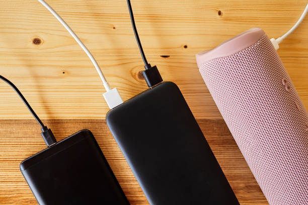istock Powerbank charges smartphone and portable speaker using usb. Close-up, selective focus 1409754883