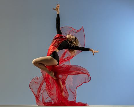 dancer with red textile in motion
