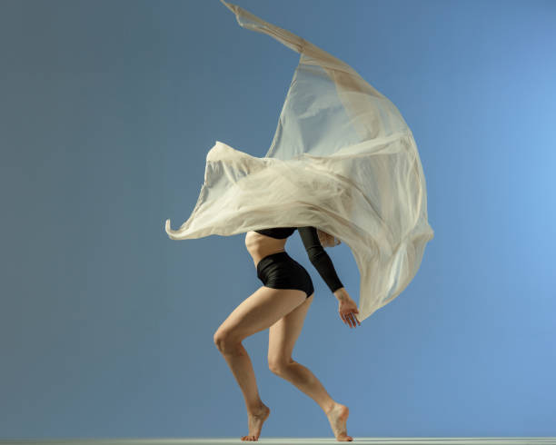 dancer in midair with red textile