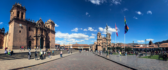 Candid panoramic street view of pedestrians in the Plaza de Armas (Main Square) in Cusco, Peru