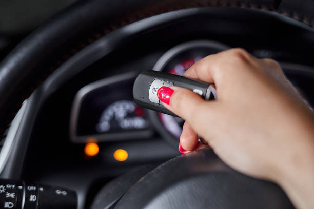 istock The car owner holds in his hand a remote control device for keyless entry against the background of the car dashboard 1409756032