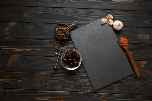 Dark cooking banner. Vegetables and spices on the kitchen table. Top view. Free space for your text. stock photo