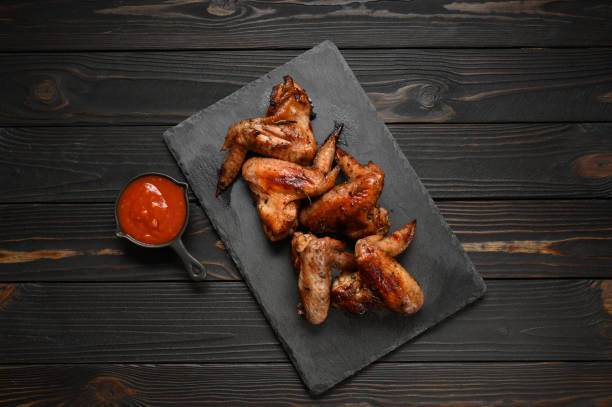 istock appetizing chicken wings grilled barbecue with spices and vegetables until crisp 1409758389