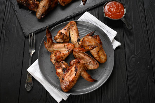 istock appetizing chicken wings grilled barbecue with spices and vegetables until crisp 1409758399