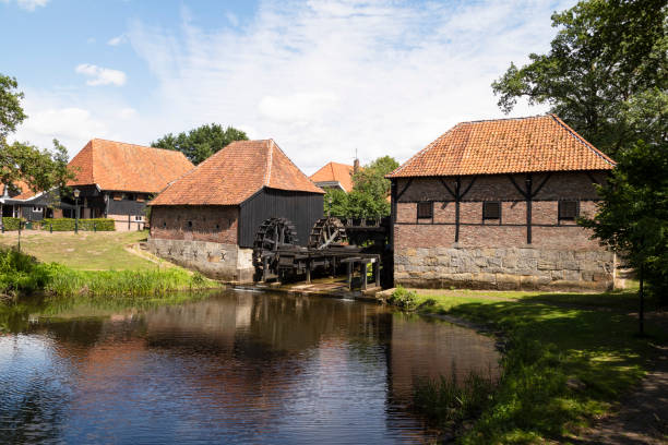 Oostendorper watermill; a double, water-driven mill with three undershot wheels. Oostendorper watermill; a double, water-driven mill with three undershot wheels on the Buurserbeek south of the Dutch village of Haaksbergen in Overijssel. old flour mill stock pictures, royalty-free photos & images