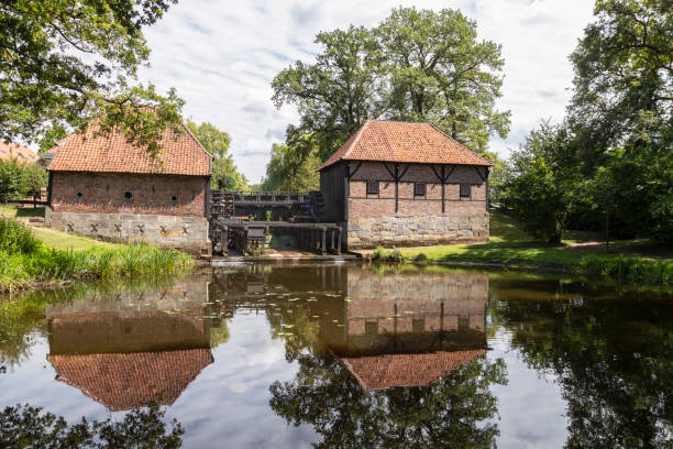 Oostendorper watermill; a double, water-driven mill with three undershot wheels. Oostendorper watermill; a double, water-driven mill with three undershot wheels on the Buurserbeek south of the Dutch village of Haaksbergen in Overijssel. old flour mill stock pictures, royalty-free photos & images
