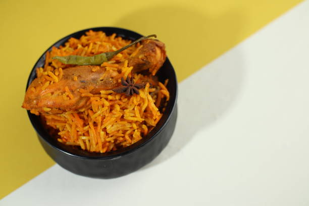 istock Dum Handi chicken Biryani is prepared in an earthen or clay pot called Haandi. Popular Indian non vegetarian food, Biryani with chicken. Traditional Indian dish of rice and chicken marinated in spices and yoghurt.Top view. natural wooden background. 1409761505
