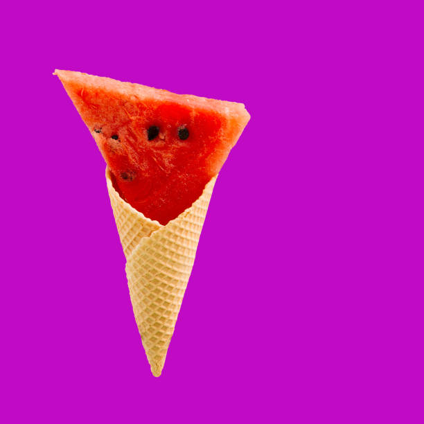istock Watermelon slices in an ice cream cone on magenta bacground . Summer concept 1409763711