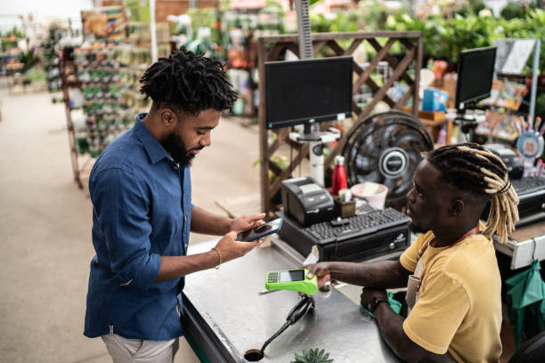 istock Man paying using contactless payment in a garden store 1409763941