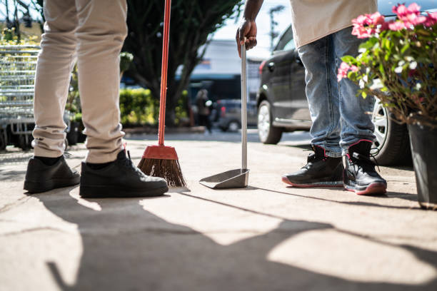 Coworkers cleaning garden center