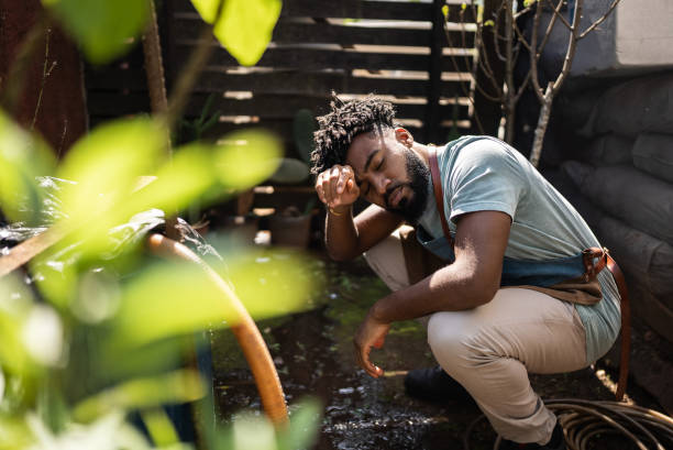 Tired young man working at a garden center