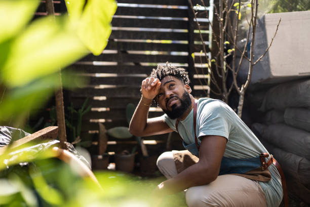 istock Tired young man working at a garden center 1409764309