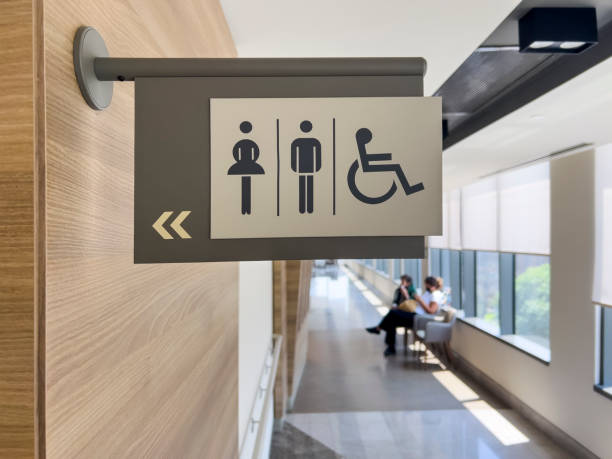 Female, male wheelchair access WC sign stock photo