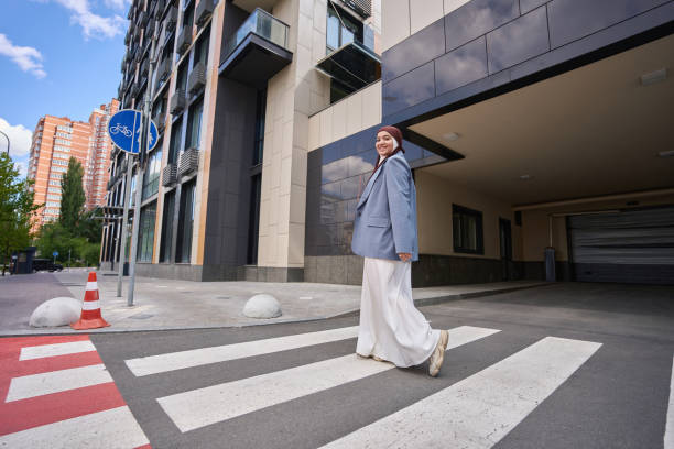 istock Arab woman crossing the road on a zebra 1409766288