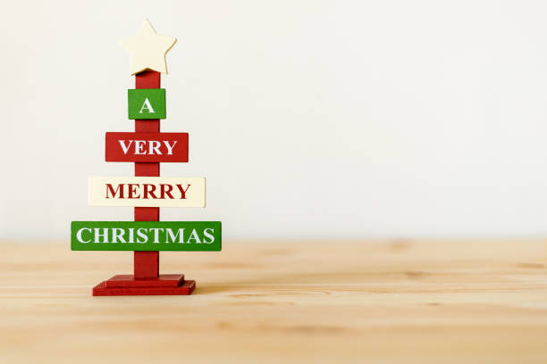 istock Christmas decorative wooden tree on table with copy space for text. A very Merry Christmas 1409766467