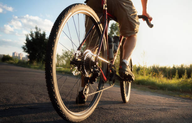 istock Cyclist stands on the road at sunset. 1409767446
