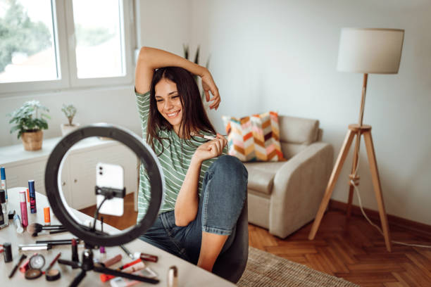 istock Female influencer vlogging online with smartphone cam about make up 1409767950