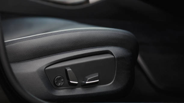 istock Car seat electronic switch button. lever for electronic seat adjustment in a modern premium car. Seat memory option. Close up of seat bottoms. 1409768054