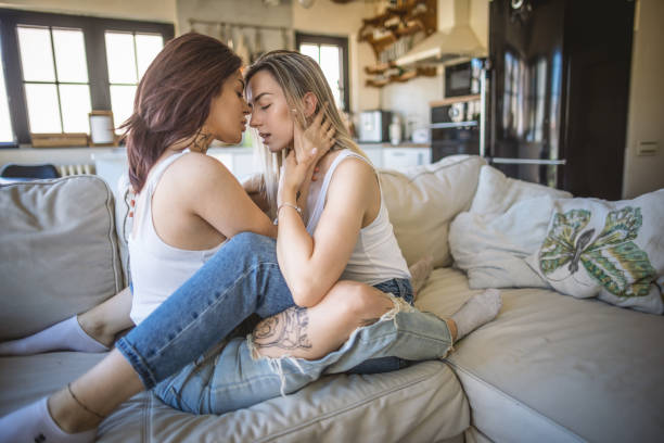 istock Lesbian couple share cuddling on the sofa bed 1409769030