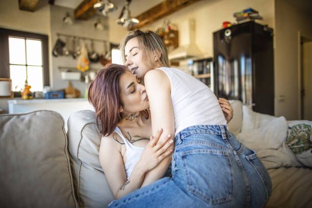 istock Lesbian couple share cuddling on the sofa bed 1409769896