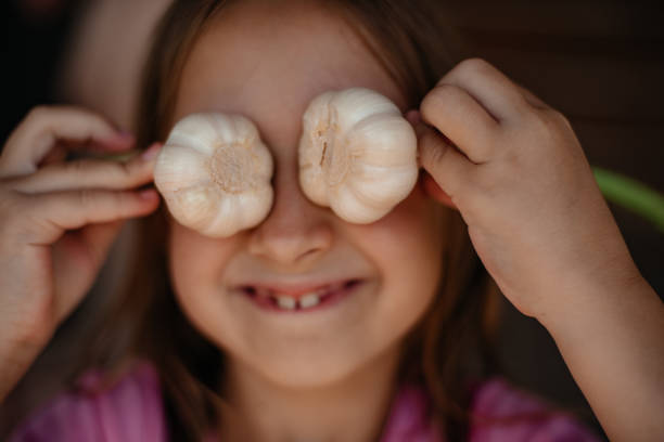 istock Girl posing with garlic in her hands. 1409770131
