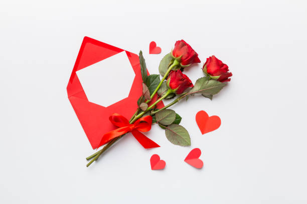 istock Valentine day composition with Envelope, rose flower and Red heart on table. Top view, flat lay. Holiday concept 1409770160