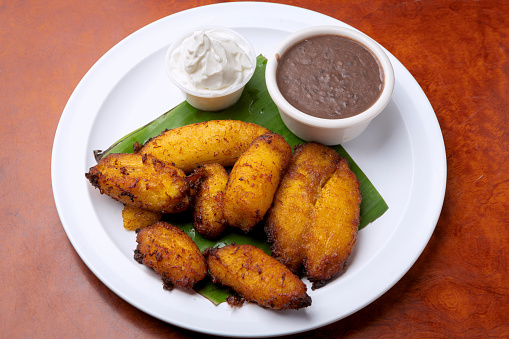 Maduro fried plantains with cream and beans
