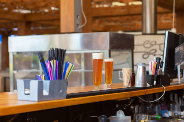 istock Two glasses of beer placed on bar counter. 1409772211