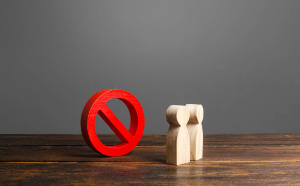 istock People looking at red prohibition sign NO. prohibition, taboo, and rejection. Conservatism, misunderstanding new. Laws Restrictions of rights and freedoms. Fear and prejudice. Insurmountable obstacle 1409773403