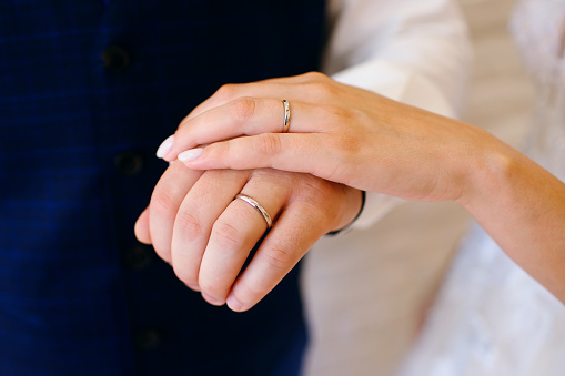 Wedding, close-up hand of the bride and groom, wedding rings, horizontal photo, free space for text, decoration, hug, loving man and woman