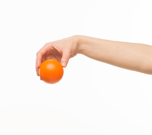 istock hand holding orange sponge ball isolated 1409775635
