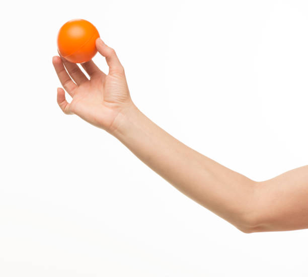 istock hand holding orange sponge ball isolated 1409775637