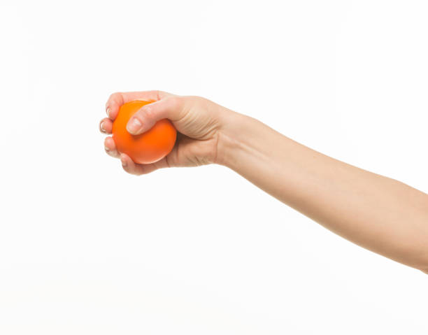 istock hand holding orange sponge ball isolated 1409775638