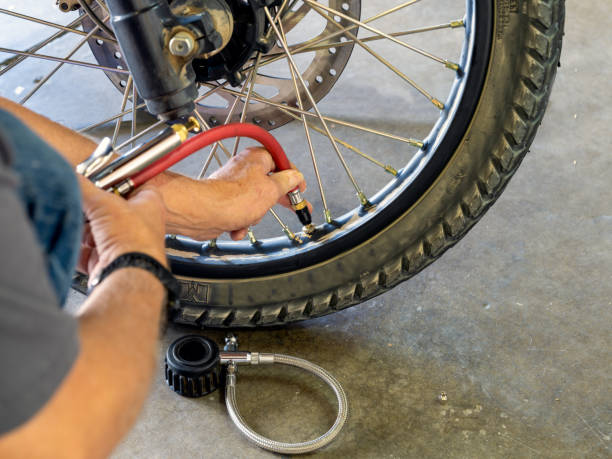 istock Checking air pressure on motorcycle tire 1409778132