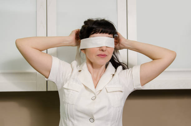 blindfolded female entrepreneur with hypnotic eyeglasses in the office.