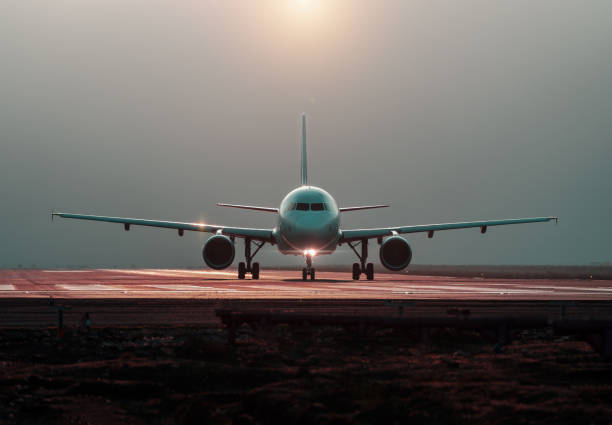 istock commercial airplane preparing for takeoff on the runway, front view 1409779860
