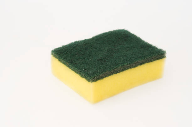 Dishwashing sponge isolated on white .